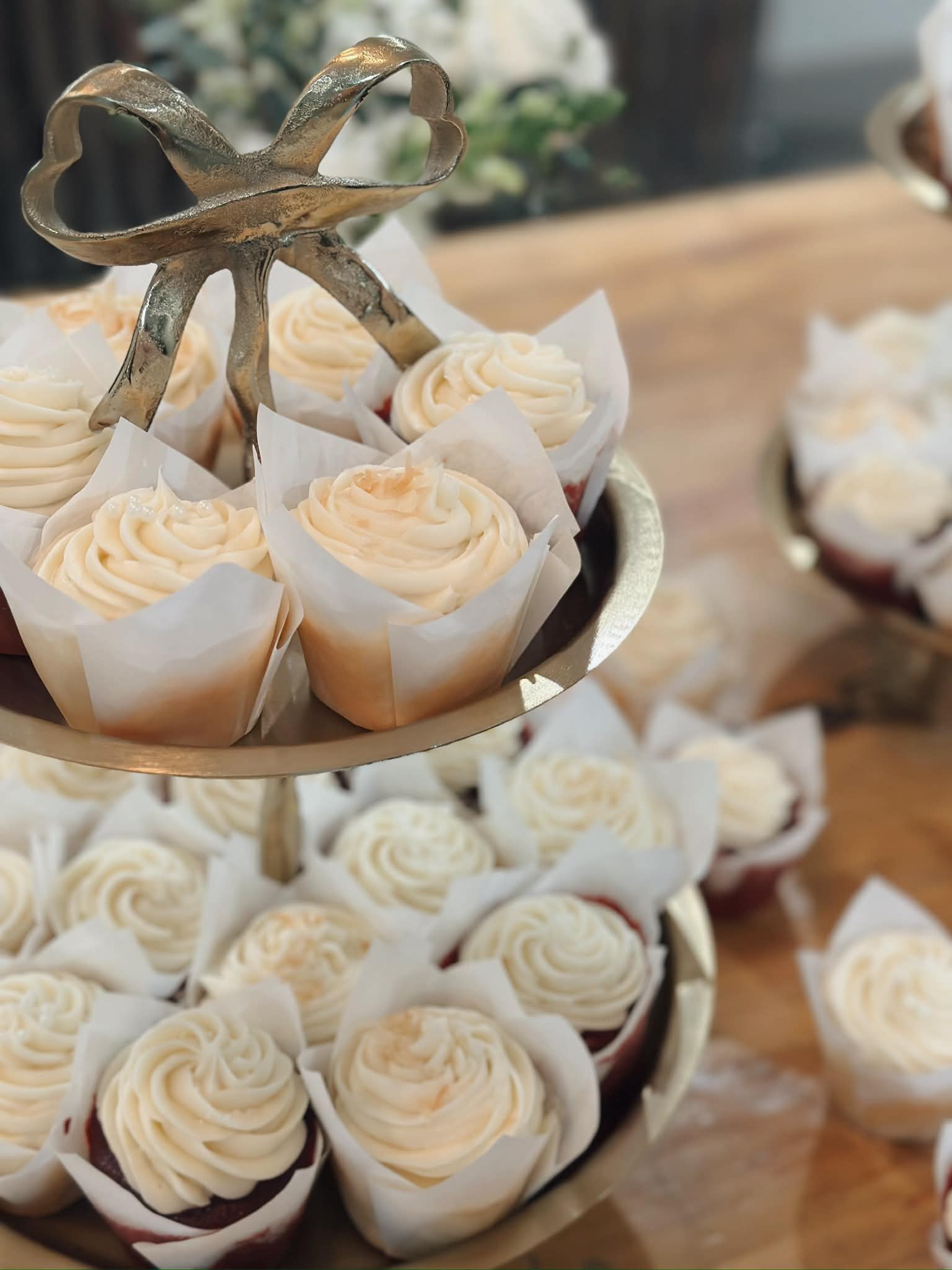 Elegant gold stand with vanilla rosette cupcakes